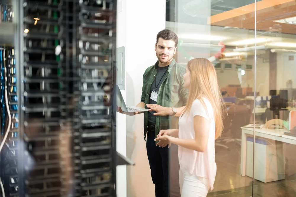 a picture of two Cisco Certified Network Professional (CCNP) Security working on their server